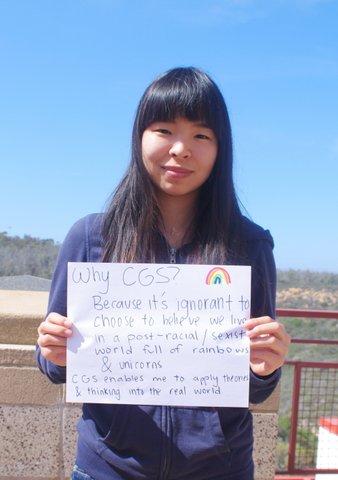 Student holding paper with reasons for why to major in CGS.